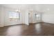 Bright living room featuring wood floors, white walls and large windows at 28610 E 8Th Pl, Watkins, CO 80137