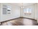 Bright dining room featuring wood floors, white walls, and a modern chandelier at 28610 E 8Th Pl, Watkins, CO 80137