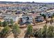 Expansive aerial view of the neighborhood and this home's backyard, with surrounding homes and distant views at 3131 Keepsake Way, Castle Rock, CO 80109