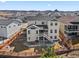 Spacious back exterior with a well-maintained lawn, patio, fire pit, and wooden fence; view of the surrounding neighborhood at 3131 Keepsake Way, Castle Rock, CO 80109