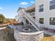 Stone backyard with fire pit, outdoor seating and multilevel patio areas at 3131 Keepsake Way, Castle Rock, CO 80109