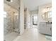 Elegant bathroom with herringbone-patterned shower, double vanity, and plenty of natural light at 3131 Keepsake Way, Castle Rock, CO 80109