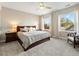 Sun-filled bedroom with large windows, a king bed and comfortable seating at 3131 Keepsake Way, Castle Rock, CO 80109