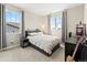 Bright bedroom features neutral decor, bedside table and large windows with a view at 3131 Keepsake Way, Castle Rock, CO 80109