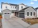 Beautiful two-story home featuring a three car garage, neutral gray paint, and professional landscaping at 3131 Keepsake Way, Castle Rock, CO 80109
