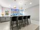 Basement kitchen area features modern cabinets, barstool seating, and stylish lighting at 3131 Keepsake Way, Castle Rock, CO 80109