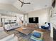 Bright open-concept living room with kitchen and dining space; vaulted ceiling and natural lighting at 3131 Keepsake Way, Castle Rock, CO 80109