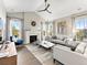 Bright and inviting living room with a fireplace, large windows, hardwood floors, and vaulted ceiling at 3131 Keepsake Way, Castle Rock, CO 80109
