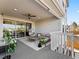Inviting covered patio with comfortable seating, hanging chair, and outdoor string lights for relaxing at 3131 Keepsake Way, Castle Rock, CO 80109