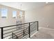 Bright staircase with modern metal railing and chandelier provide a functional and elegant feature at 3131 Keepsake Way, Castle Rock, CO 80109