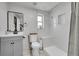 Bright bathroom with a shower, tub, modern vanity, and sleek fixtures throughout at 2544 S Raleigh St, Denver, CO 80219