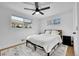 Cozy bedroom with a ceiling fan, hardwood floors, and natural light from the large windows at 2544 S Raleigh St, Denver, CO 80219