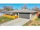 Ranch style home with an attached garage and covered patio at 2544 S Raleigh St, Denver, CO 80219