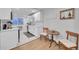 Modern kitchen with white cabinets, stainless steel appliances, and a cozy breakfast nook at 2544 S Raleigh St, Denver, CO 80219
