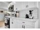 This kitchen showcases ample countertop space, modern appliances, and sleek, white cabinetry at 2544 S Raleigh St, Denver, CO 80219