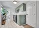Charming laundry room with green cabinets, modern washer and dryer, and tiled floors at 2544 S Raleigh St, Denver, CO 80219