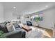 Spacious living room featuring a cozy sofa, a large window, and hardwood floors at 2544 S Raleigh St, Denver, CO 80219