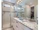 Modern bathroom features dual sinks, granite countertops, and walk-in shower with glass door at 152 Western Sky Cir, Longmont, CO 80501