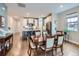 Bright dining room features hardwood floors, kitchen access, and a dining table with seating for six at 152 Western Sky Cir, Longmont, CO 80501