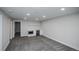 Finished basement area with modern recessed lighting, kitchenette, and neutral carpet at 320 S Jersey St, Denver, CO 80224