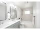 Bright bathroom features double sinks, modern fixtures, and subway tile in the shower area at 320 S Jersey St, Denver, CO 80224