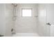 Close-up view of modern subway tile bathroom, featuring a shower and sleek fixtures at 320 S Jersey St, Denver, CO 80224