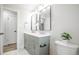 Bathroom with gray vanity with double sinks, modern fixtures, and neutral walls at 320 S Jersey St, Denver, CO 80224
