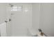 Bright and airy bathroom shower featuring sleek, vertical tiling, a small window, and a built-in seat at 320 S Jersey St, Denver, CO 80224