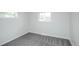 Bright bedroom featuring neutral carpet, two large windows, and ample natural light at 320 S Jersey St, Denver, CO 80224