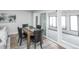Charming dining area adjacent to the living room, featuring a modern table set and a view of the outdoor patio at 320 S Jersey St, Denver, CO 80224
