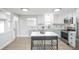 Modern kitchen with stainless steel appliances, a movable island, ample cabinet space, and stylish backsplash at 320 S Jersey St, Denver, CO 80224