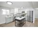 Bright kitchen with stainless steel appliances, island, and ample counter space, perfect for cooking and entertaining at 320 S Jersey St, Denver, CO 80224
