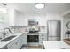 Well-appointed kitchen features stainless steel appliances, a modern backsplash, and plenty of cabinet and counter space at 320 S Jersey St, Denver, CO 80224