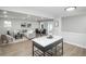 Open-concept living room featuring modern decor, dining area, and an island with a white countertop at 320 S Jersey St, Denver, CO 80224