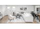 Cozy living room seamlessly connects to the dining area, showcasing hardwood floors, neutral tones, and abundant natural light at 320 S Jersey St, Denver, CO 80224