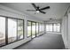 Bright sunroom with large windows, ceiling fans, and views of the landscaped backyard at 320 S Jersey St, Denver, CO 80224