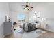 Bright bedroom features a ceiling fan, large window, and stylish decor at 5255 Memphis St # 219, Denver, CO 80239