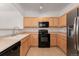 Well-lit kitchen with stainless steel appliances and neutral-toned cabinetry at 5255 Memphis St # 219, Denver, CO 80239