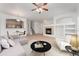 Open-concept living room with a cozy fireplace and adjacent kitchen space at 5255 Memphis St # 219, Denver, CO 80239