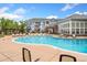 Community pool featuring ample lounge seating, clubhouse, and well-maintained landscaping at 5255 Memphis St # 219, Denver, CO 80239