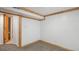 Basement with light carpet and wooden beam trim at 766 Fulton Ave, Brighton, CO 80601