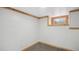 Finished basement room with carpeting, natural light from the basement window, and wood trim at 766 Fulton Ave, Brighton, CO 80601