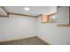 A finished basement with a window and carpet flooring at 766 Fulton Ave, Brighton, CO 80601