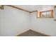 Finished basement room with carpeting, natural light from the basement window, and wood trim at 766 Fulton Ave, Brighton, CO 80601