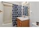 Bright bathroom with a tiled shower, modern vanity, and ample lighting for a refreshing and functional space at 766 Fulton Ave, Brighton, CO 80601