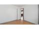Bright and airy bedroom featuring hardwood floors, neutral walls, and open doorway at 766 Fulton Ave, Brighton, CO 80601