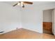 Bright bedroom featuring wood-look floors, white walls, and a closet at 766 Fulton Ave, Brighton, CO 80601