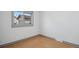Simple bedroom design with a large window allowing natural light and hardwood floors at 766 Fulton Ave, Brighton, CO 80601