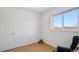 Bright bedroom features laminate floors, white walls, a window and a chair at 766 Fulton Ave, Brighton, CO 80601