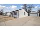 Charming single-story home featuring a long driveway and detached garage at 766 Fulton Ave, Brighton, CO 80601